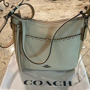 Brand new Coach shoulder bag. Long strap and top zip closure.